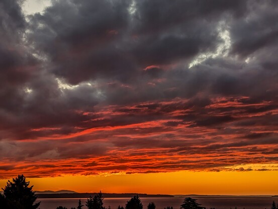 Sunset over Puget Sound with high clouds.
