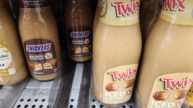 glass jars of iced coffee one with a Snickers logo on it and the other with a Twix logo on it 